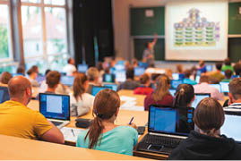 Speaker Giving a Talk at Business Meeting. Audience in the conference hall. Business and Entrepreneurship. Copy space on white board.